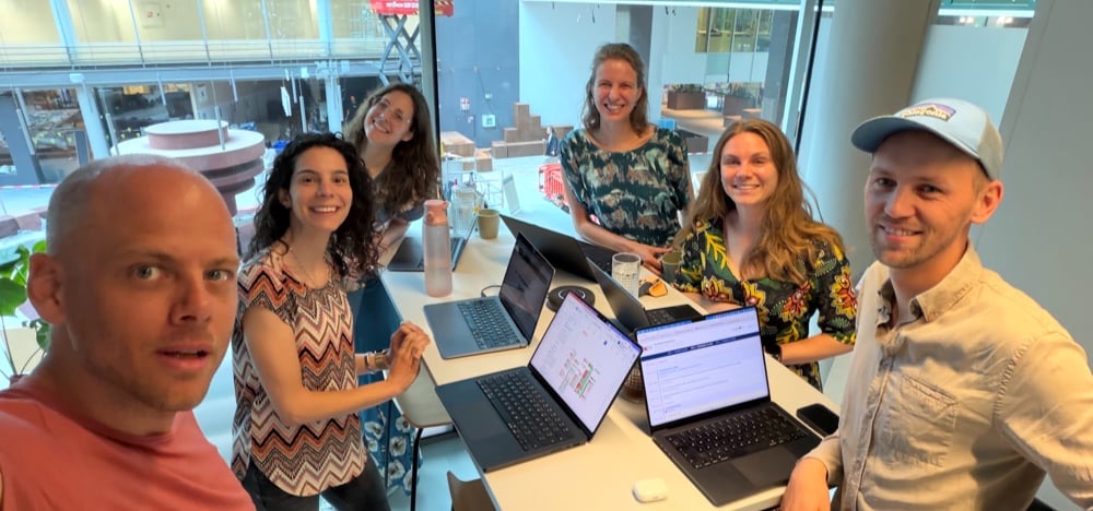 The Moral Fabric team around a table of laptops at our first in-person weekly meeting.